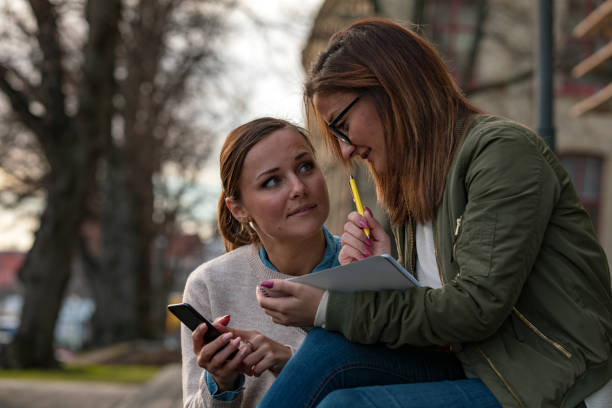 Two female students looking at phone