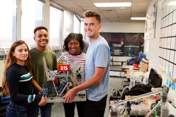 istock Portrait Of University Students Carrying Machine In Science Robotics Or Engineering Class 1133836495