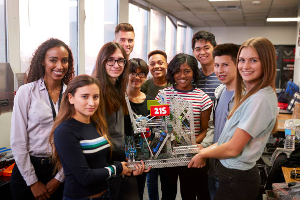 istock Portrait Of University Students With Teacher Holding Machine In Science Or Robotics Class 1133836609