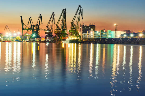 istock Evening panorama of the cargo port. Loading and unloading of ships. Crane 1133836907