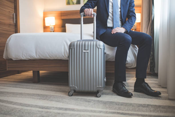 istock Young businessman with a suitcase in room 1133838020
