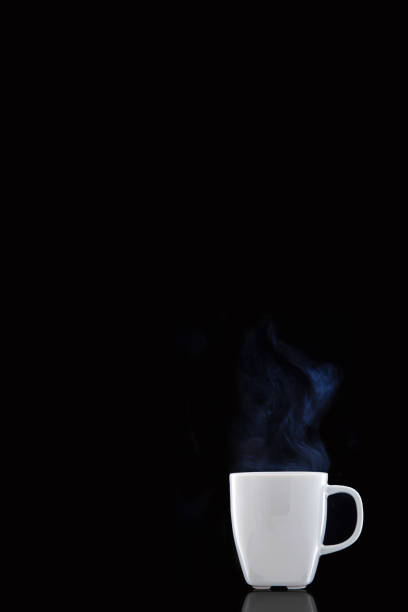 istock White cup with hot coffee. Steam Rising. Black background. 1133838263