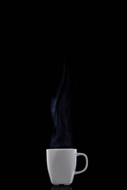 istock White cup with hot coffee. Steam Rising. Black background. 1133838595