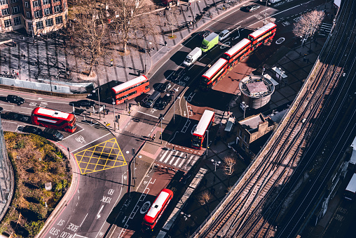 Aerial road view. London buses on the road and parking on the side of road