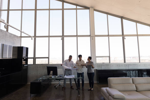 istock Business colleagues discussing over house model in office 1133839809