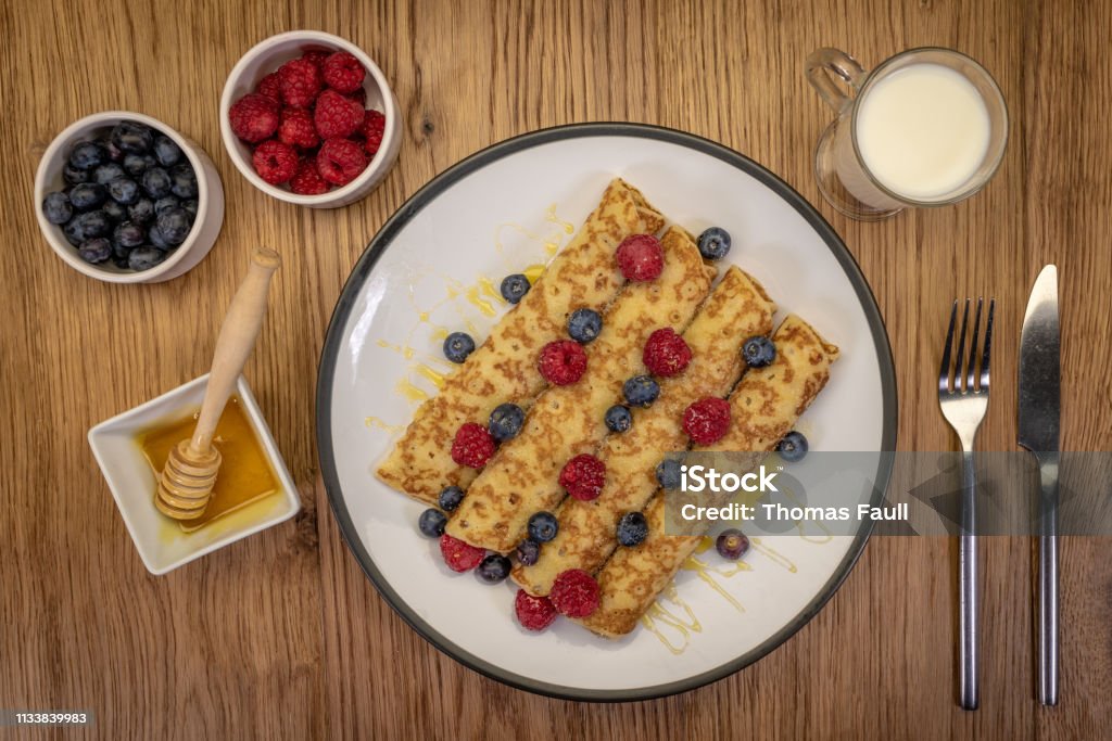 Pancakes with honey, raspberries and blueberries Blueberry Stock Photo