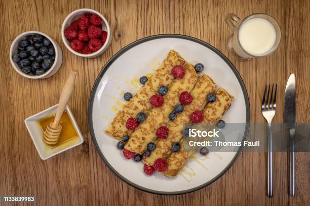 Pancakes With Honey Raspberries And Blueberries Stock Photo - Download Image Now - Blueberry, Dessert - Sweet Food, Dinner