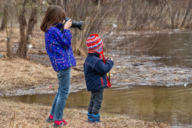 istock Children photographers by the river 1133841902