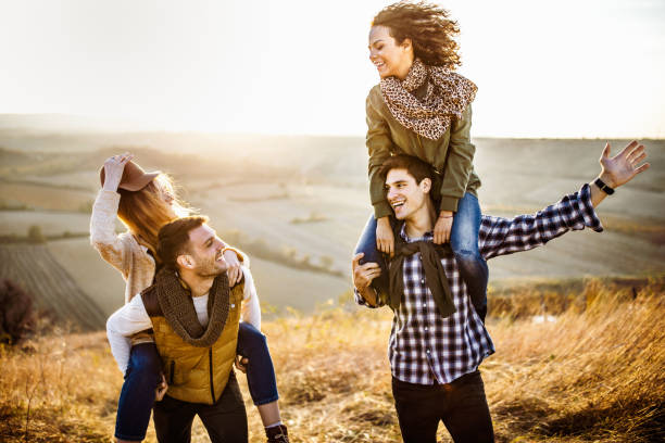 istock Young carefree couples having fun during autumn day on a hill. 1133842372