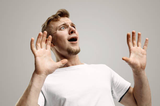 istock Portrait of the scared man on gray 1133842391