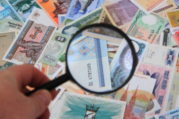 istock money different banknotes with magnify glass 1133843489