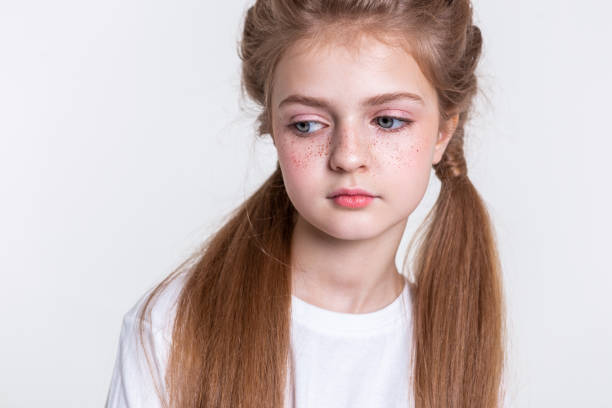 istock Tranquil light-haired girl with two long tails wearing plain white t-shirt 1133845435