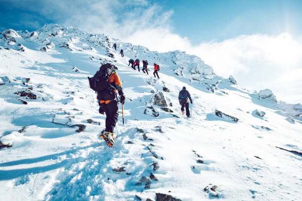 istock A group of climbers ascending a mountain in winter 1133845473