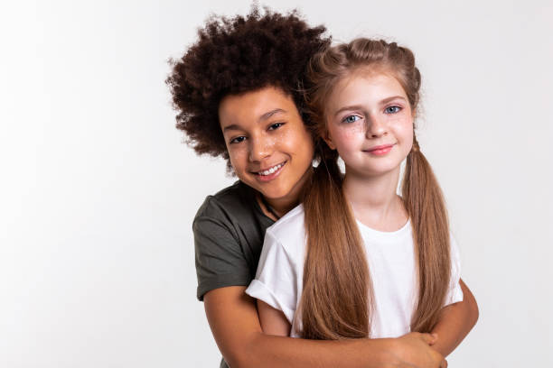 istock Cheerful dark-haired little boy tightly hugging his friend 1133845483