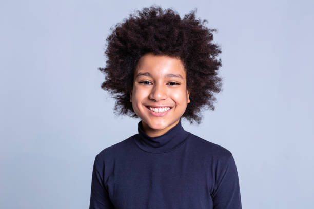 istock Pretty young boy with wide smile having African hairstyle 1133845491
