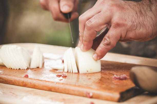 istock Slicing of a white onion. Cook hands 1133845565