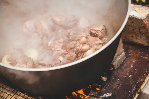 Photo of Lamb pieces with onion boiling on fire