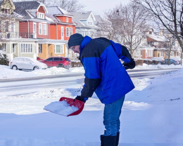 istock Man in blue coat shoveling snow 1133846566