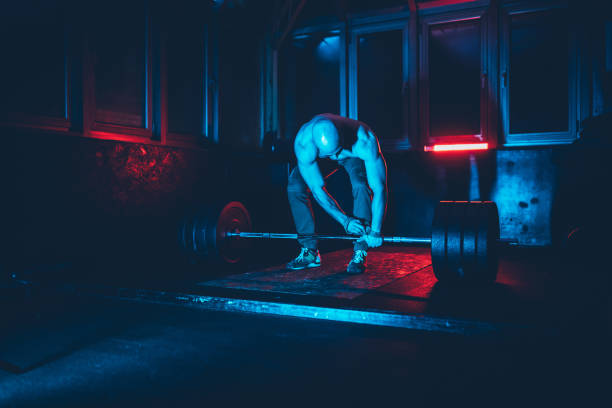 istock Handsome athlete is weightlifting 1133849052