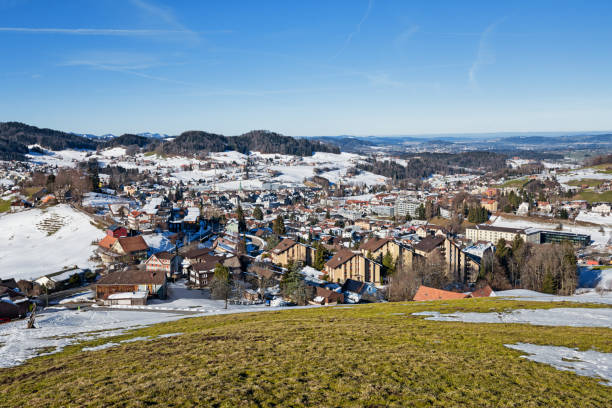 Herisau in Switzerland Herisau is the capital city of the canton Appenzell Ausserrhoden in Switzerland. Panoramic view over landscape and cityscape in springtime with some snow on the hills appenzell ausserrhoden stock pictures, royalty-free photos & images
