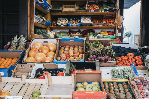 Fresh fruits and vegetables on sale at a Hampstead Community Centre market in Hampstead, London, UK. London, UK - March 2, 2019: Fresh fruits and vegetables on sale at a Hampstead Community Centre market in Hampstead, an affluent residential area of London favoured by artists and media figures. community center food stock pictures, royalty-free photos & images