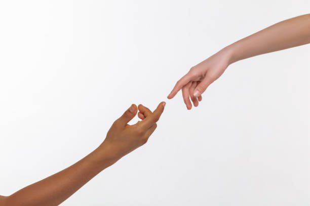 istock Pale flawless hand moving from top to bronzed hand 1133850748