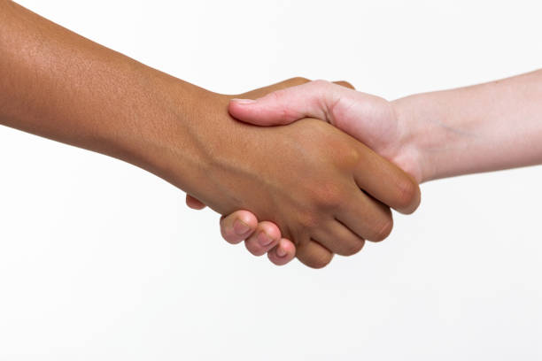 istock Pale and bronzed childish hands connecting in positive gesture 1133850762