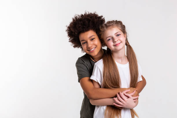 istock Young pleasant kids lovely looking together while hugging 1133850782
