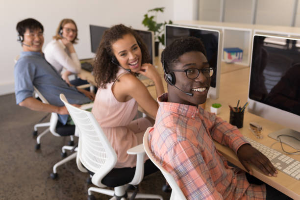 istock Executives in headset working at desk in office 1133851303