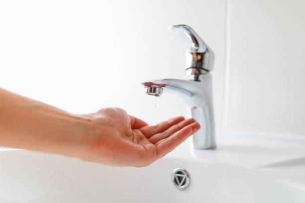 istock hand under faucet without water 1133851546