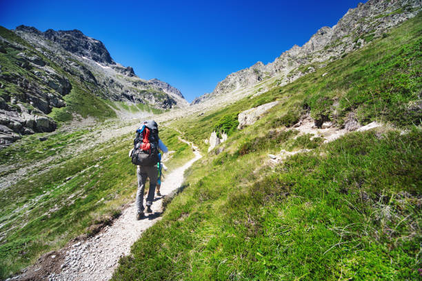 istock Father and son hiking together in mountains 1133853036