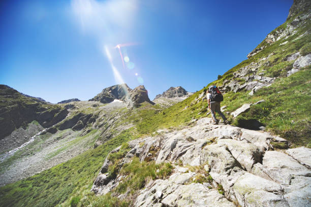 istock Father and son hiking together in mountains 1133853063