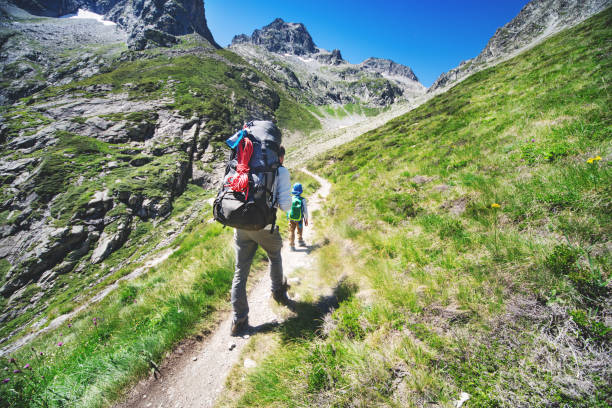 istock Father and son hiking together in mountains 1133853069