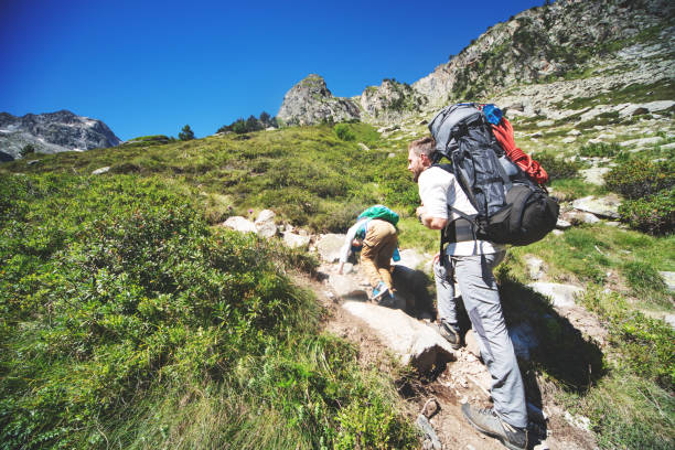istock Father and son hiking together in mountains 1133853110