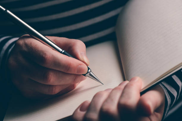 istock Close up of woman's hand writing in notebook 1133854195