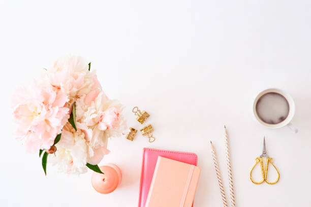 istock Flat lay blogger or freelancer workspace with a notebook and pink peonies on a white background 1133854766