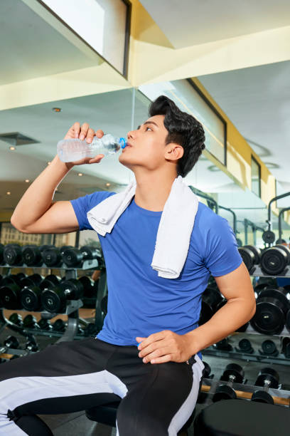 istock Sportsman drinking water after training 1133855952