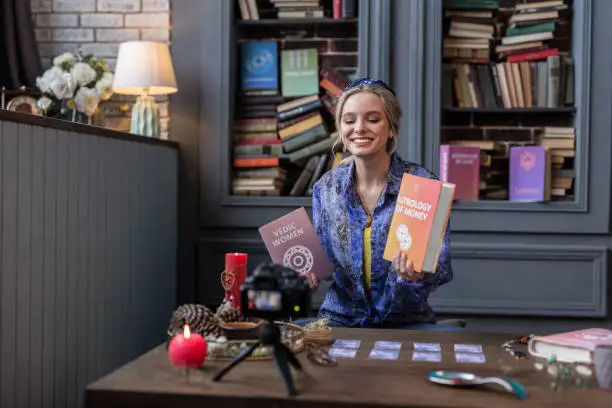 Photo of Pleasant blonde young woman speaking about books