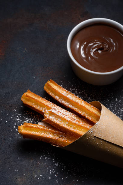 istock Churros in paper bag with sugar and chocolate 1133858008