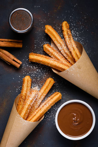 istock Churros with sugar powder with chocolate sauce dip and cinnamon sticks 1133858317