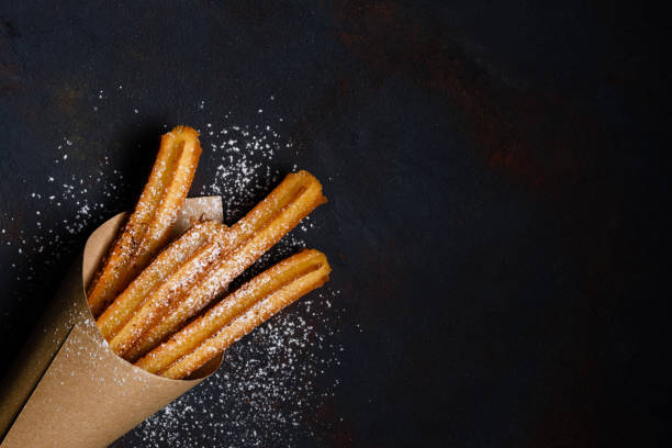 istock Churros sticks fresh hot in paper bag 1133858666