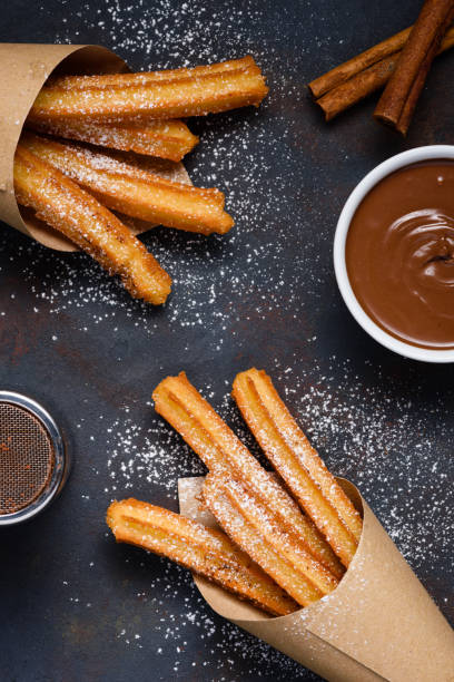 istock Churros with sugar powder chocolate sauce dip and cinnamon sticks 1133859198