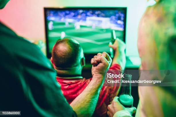 Friends Happy About Their Favorite Club Winning Soccer Match Stock Photo - Download Image Now