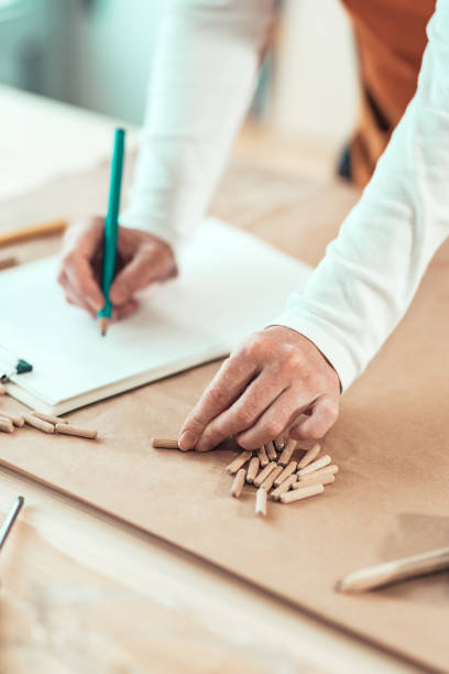 istock Female carpenter working with wooden dowels 1133860045