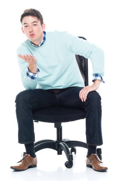 istock Handsome young man sitting and blowing a kiss 1133861138