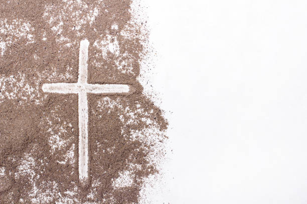 istock Cross and ash on white background - symbol of Ash Wednesday. Copy space 1133861267