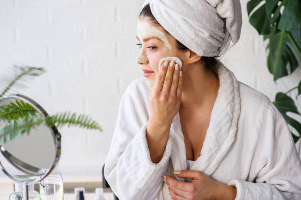 Young woman cleaning face with natural cosmetics Young woman cleaning face with natural cosmetics. Clean fresh skin care. woman washing face stock pictures, royalty-free photos & images