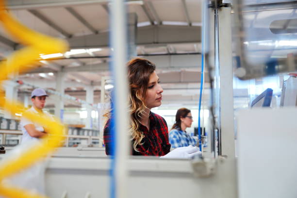 istock Female technician working with manufacturing equipment in a factory 1133861923