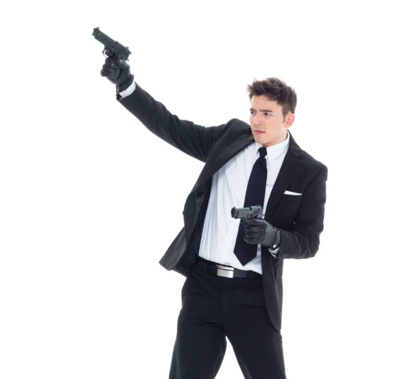 istock Handsome businessman holding a handgun 1133862492
