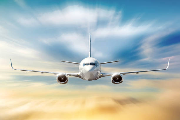 istock Airplane with motion blur effect is flying in orange clouds at sunset. Concept aviation air transport 1133863110